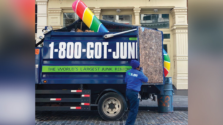 Weird Junk 2024 Giant Candy Cane Gian candy cane loaded into the back of a 1-800-GOT-JUNK? truck