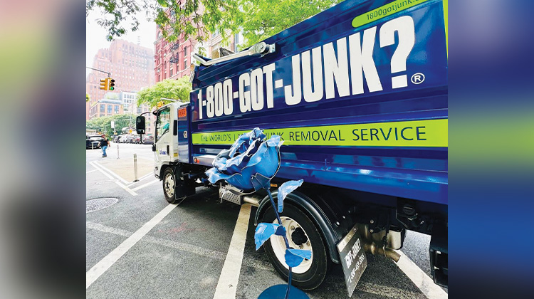 Weird Junk 2024 Giant Rose Giant blue rose leaning agains a 1-800-GOT-JUNK? truck
