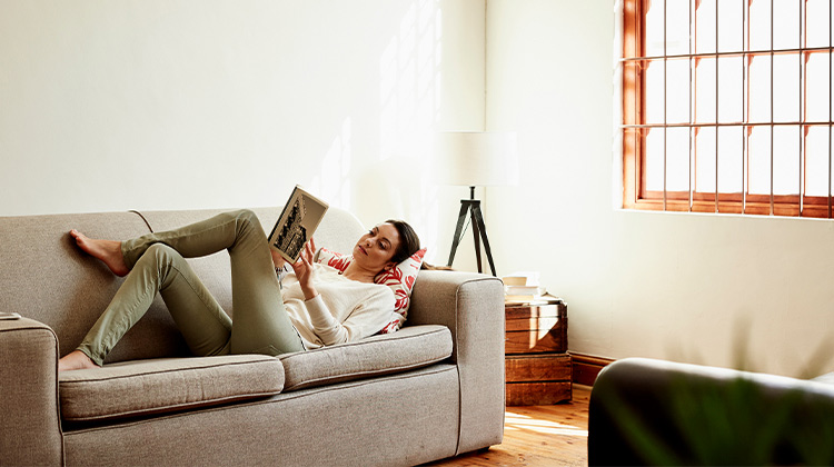 Woman reading on a couch 