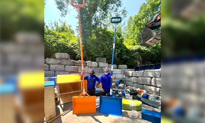 Two 1-800-GOT-JUNK? Truck Team Members with 20ft shovels.