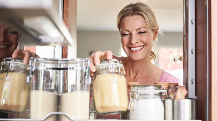 Woman reaching into a pantry for flour Woman reaching into a pantry for flour