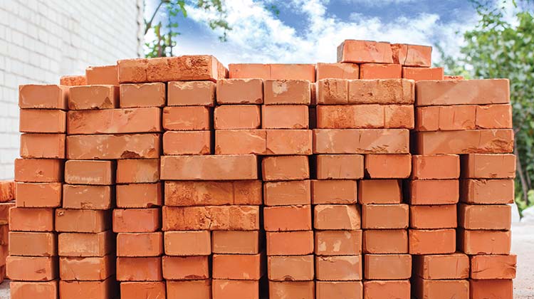 How to dispose of bricks Stack of red bricks in a residential backyard