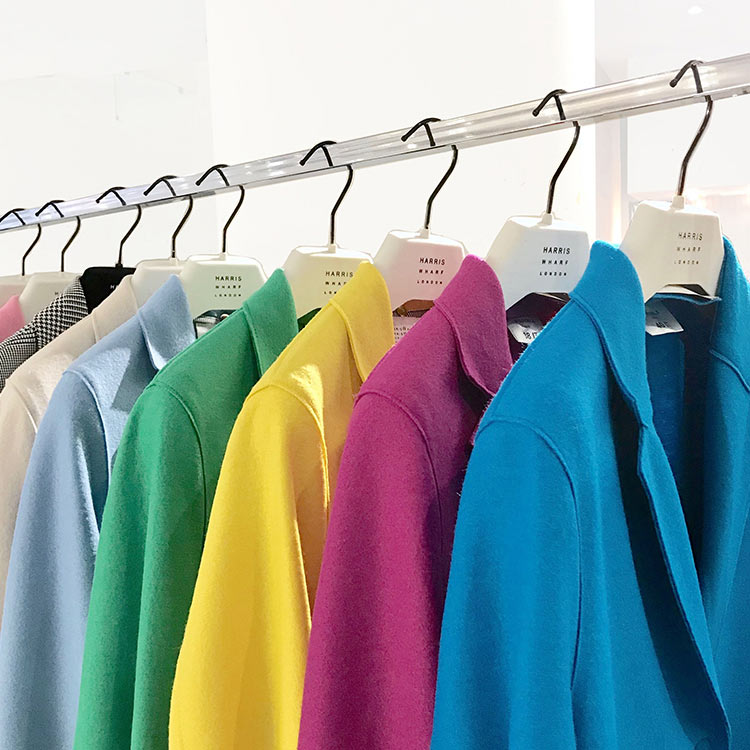 Colorful jackets on white hangers Colorful jackets on white hangers