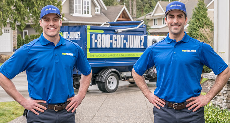 2 TOMs standing in front of a 1-800-GOT-JUNK? truck 2 TOMs standing in front of a 1-800-GOT-JUNK? truck