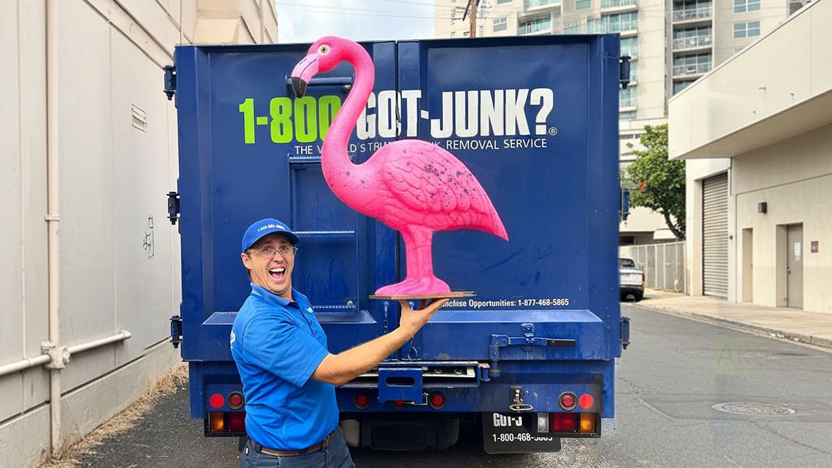 A 1-800-GOT-JUNK? Truck Team Member with a pink flamingo