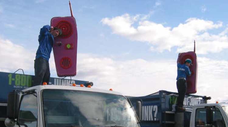 1-800-GOT-JUNK? team members holding giant walkie talkies 1-800-GOT-JUNK? team members holding giant walkie talkies